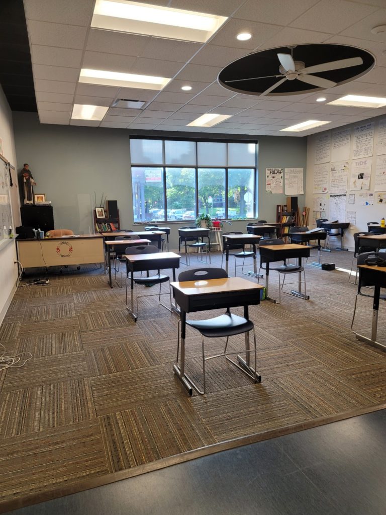 Clean classroom with desks and a large window